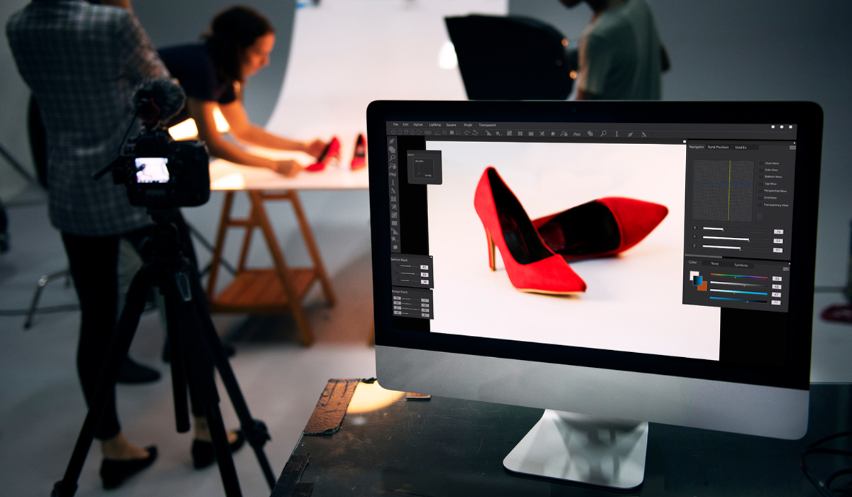 Three people in a Photography studio, computer screen in foreground displaying two red high-heel shoes